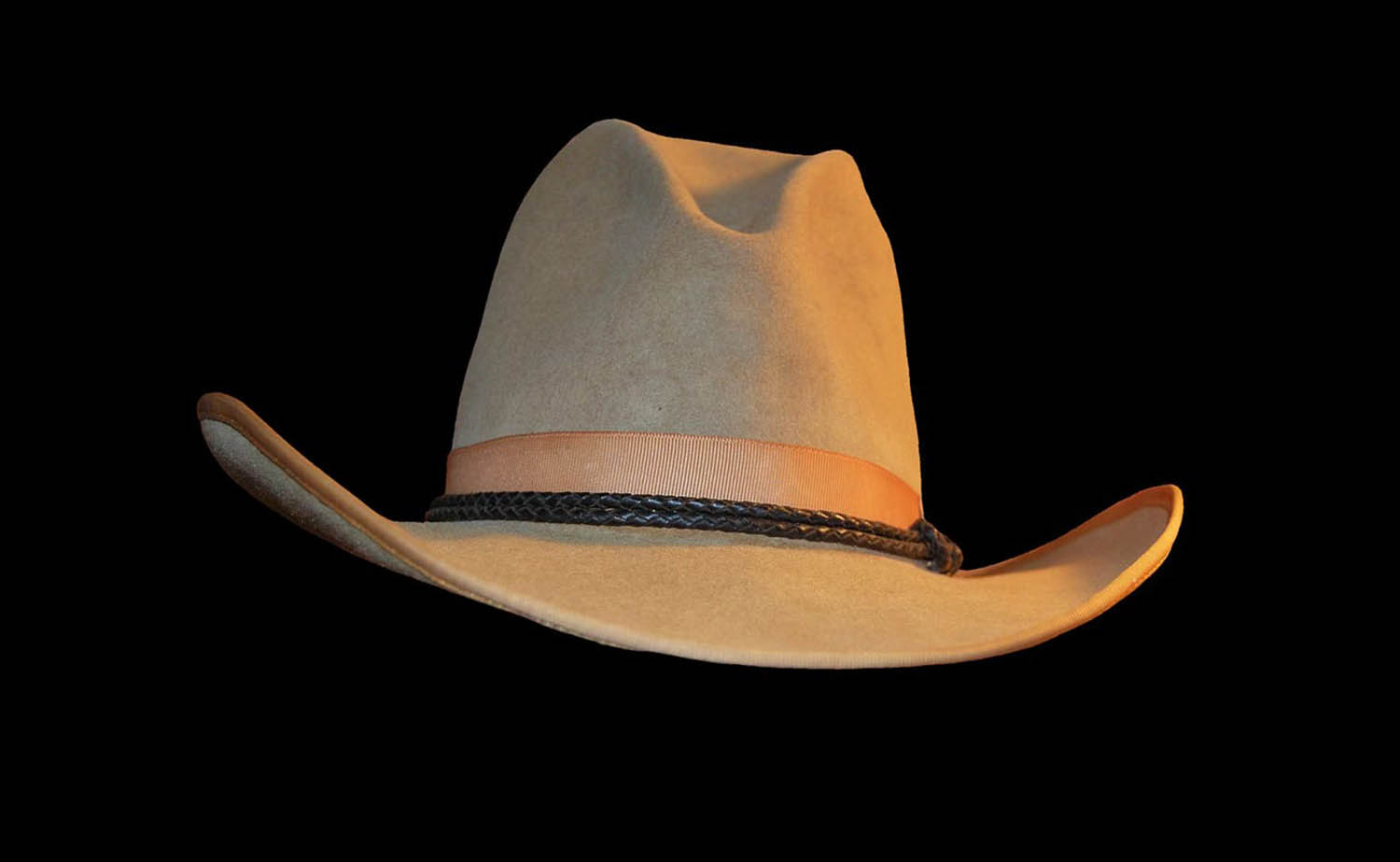 Cowboy hat suspended infront of a solid black background
